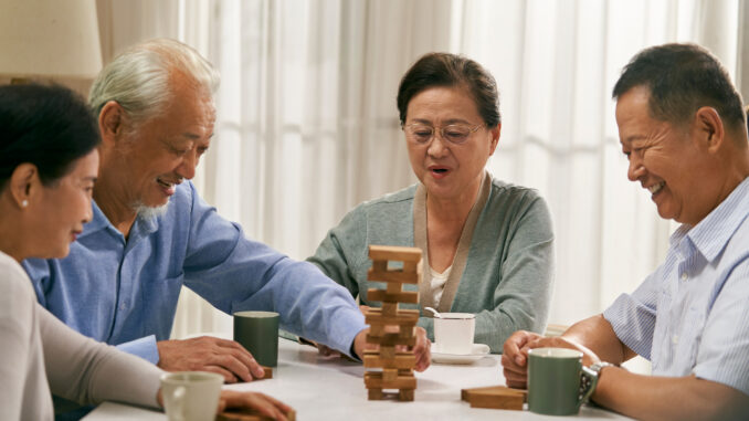 happy asian old people playing with building blocks at home